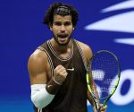 Tennis star Carlos Alcaraz hitting a forehand shot on Arthur Ashe Stadium at the US Open.
