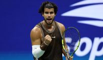 Tennis star Carlos Alcaraz hitting a forehand shot on Arthur Ashe Stadium at the US Open.