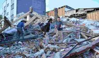 Emergency responders search through building debris following the major earthquake in Colombia.