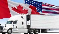 Freight trucks carrying commercial cargo waiting to cross the border between the United States and Canada.