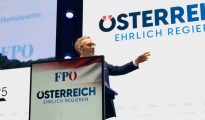 PÖ party leader Herbert Kickl speaking at a podium during a political event in Vienna.