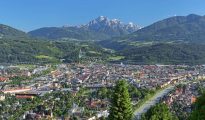 Panoramic view of Innsbruck city in Tyrol under sunny skies.