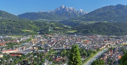 Panoramic view of Innsbruck city in Tyrol under sunny skies.