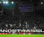 LASK players celebrating on the pitch with fans after securing a dramatic Champions League playoff victory over Celtic at Raiffeisen Arena.