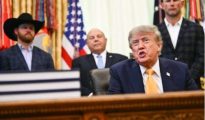 President Donald Trump speaking behind the Resolute Desk in the Oval Office at the White House.