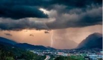 Empty open-air stage in Linz under heavy thunderstorm clouds during severe weather.