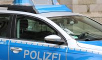 Vienna Police vehicle with blue emergency lights on a city street at night