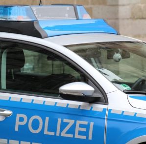 Vienna Police vehicle with blue emergency lights on a city street at night