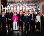Foreign ministers and delegates from Western Balkan states and European Union members posing for a group photo in front of national flags at the Berlin Process summit in Montenegro