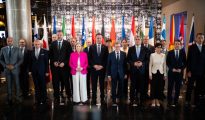 Foreign ministers and delegates from Western Balkan states and European Union members posing for a group photo in front of national flags at the Berlin Process summit in Montenegro